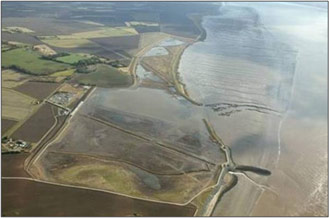 Figure 2: Aerial photograph of project area (right) after the embankment breaches (October 2003)
